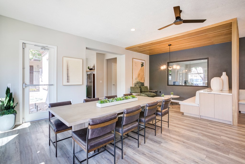 a dining room with a wooden table and chairs